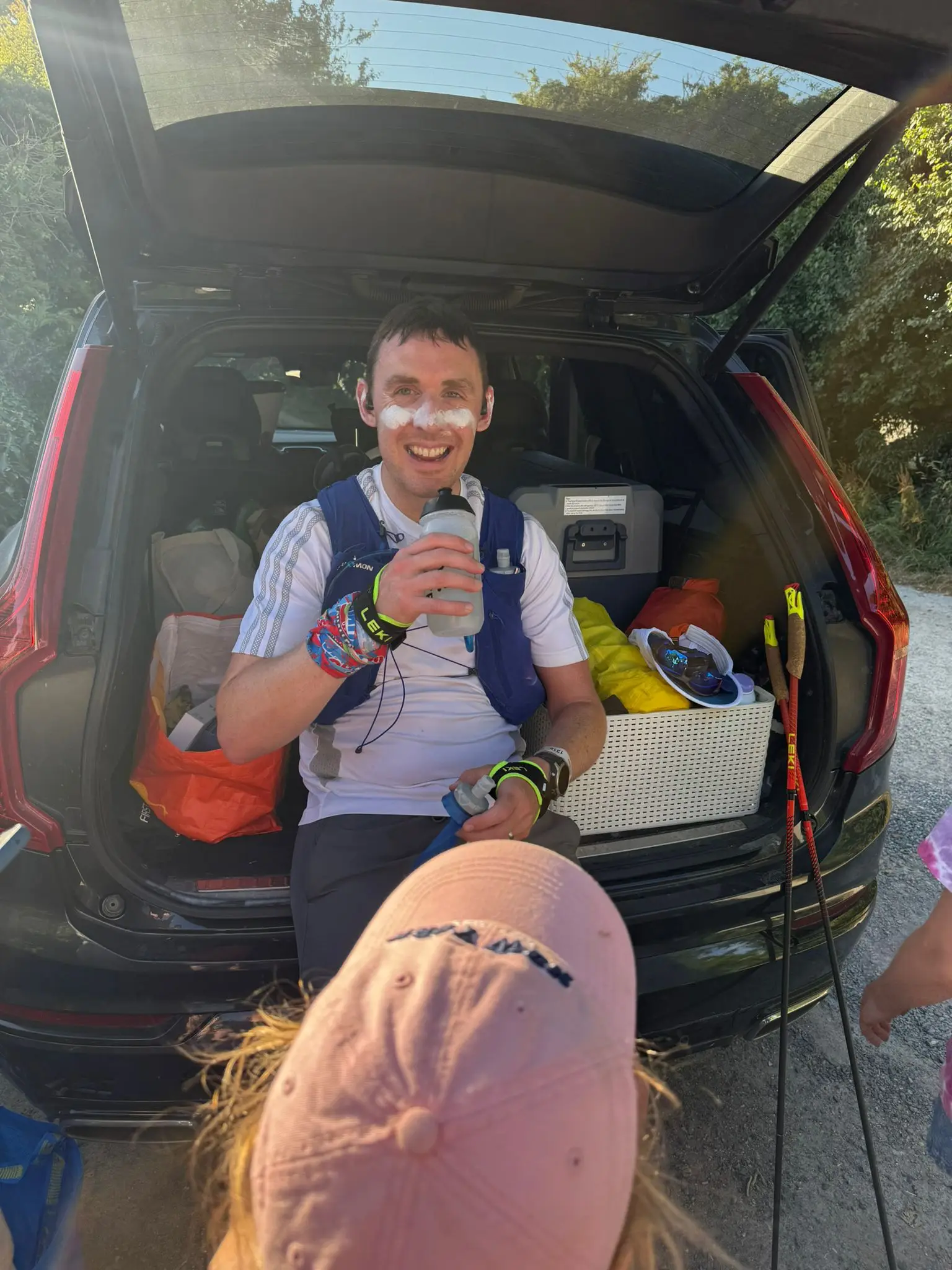 Ultra runner mid-race during a 100km ultra marathon in extreme heat, fuelling and maintaining control